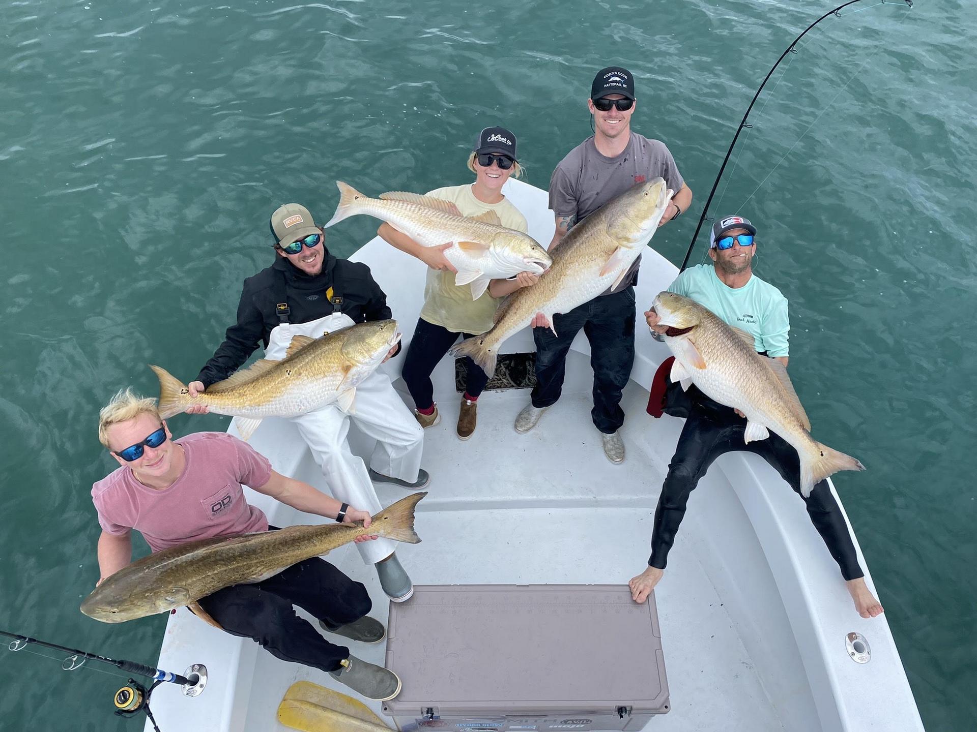 Three anglers with red drum